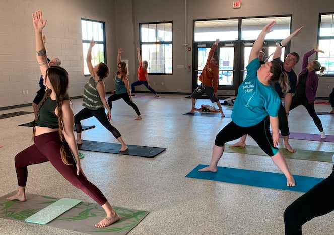Adults practicing yoga together in a Louisville community room