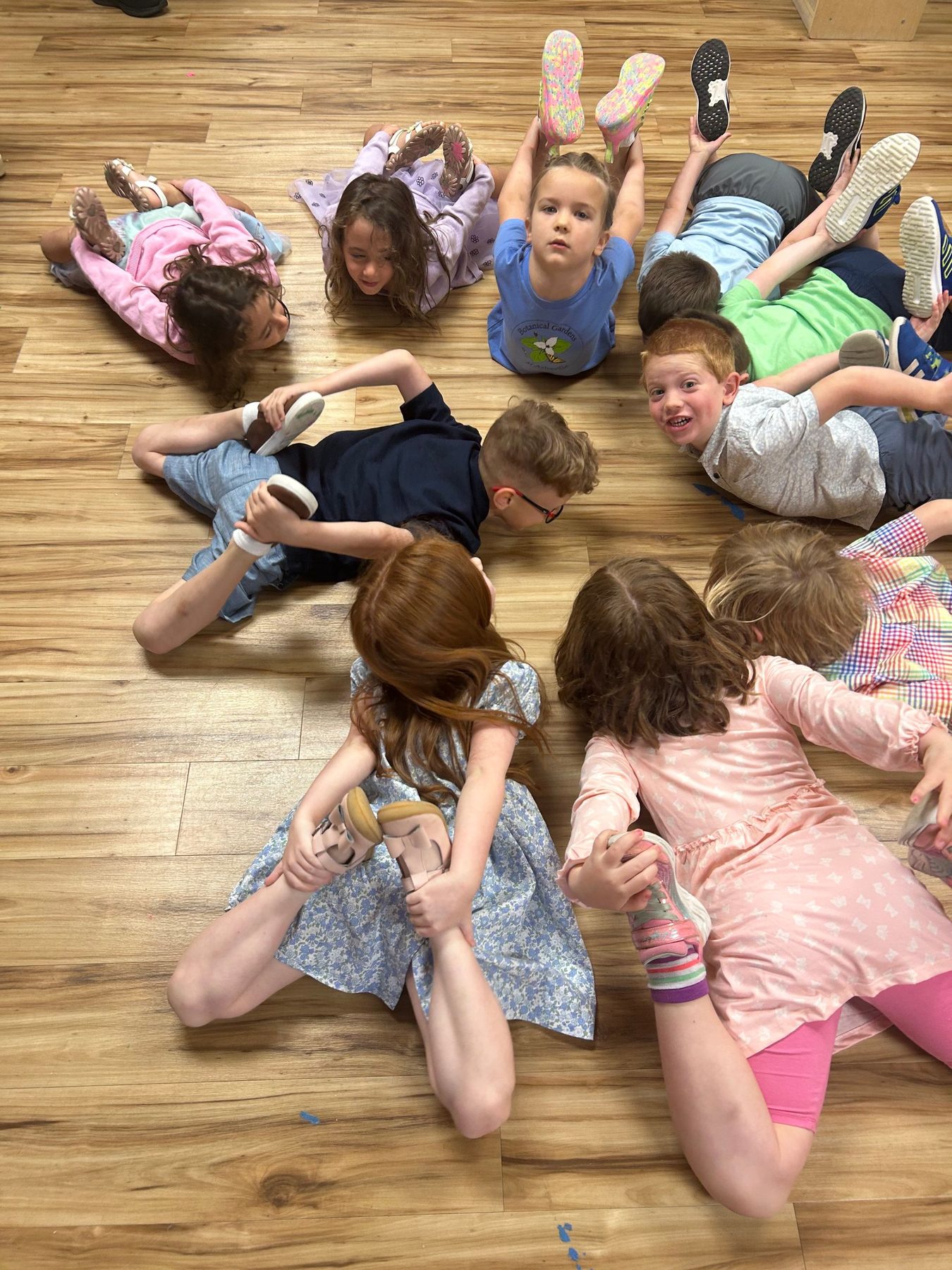 Children forming a playful circle during a group yoga activity