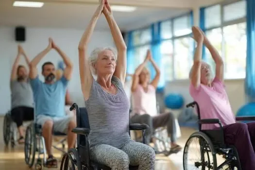 Older adults, including wheelchair users, practicing supported yoga together